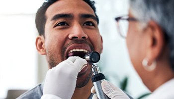 Man having his mouth checked for oral cancer