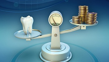 Tooth and coins on a balance scale