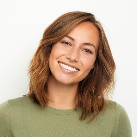 woman smiling after getting dental crowns in Eatontown