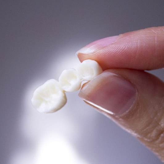 person holding a dental bridge in Eatontown