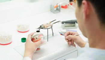 A dental technician working on dentures  