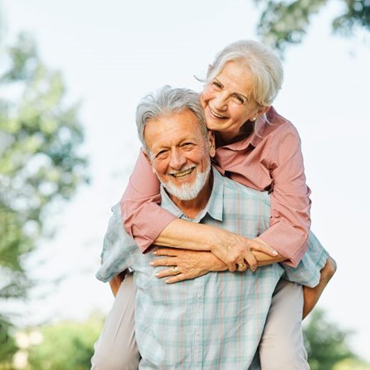 a mature couple smiling while spending time outside