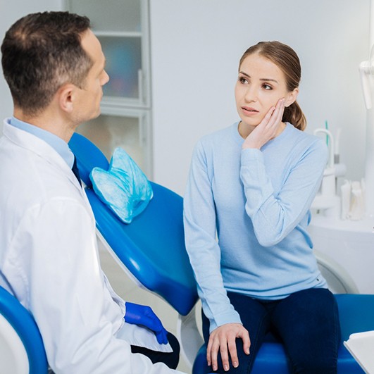Woman with tooth pain visiting an emergency dentist in Eatontown