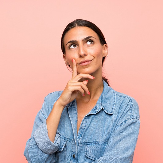 Woman smiling, thinking, and looking upward