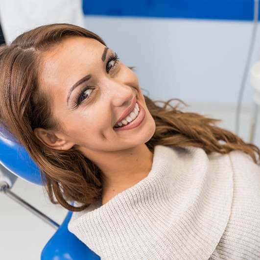 Woman smiling while visiting her Eatontown emergency dentist