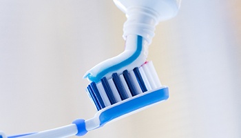 Toothbrush being applied with toothpaste