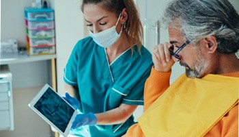 A patient viewing an X-ray before his tooth extraction in Eatontown, NJ