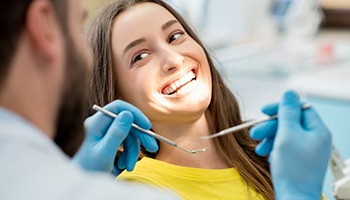 Woman smiling before getting tooth-colored fillings in Eatontown