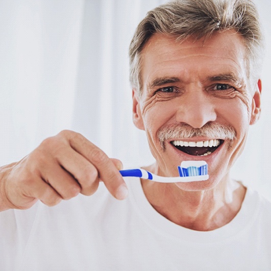 senior man brushing his teeth