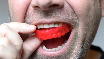 man wearing a red mouthguard