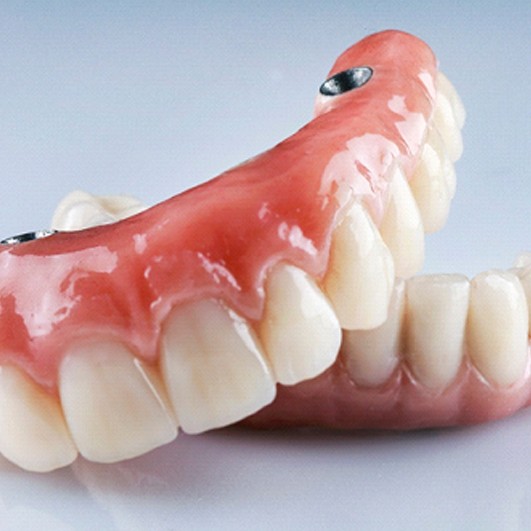 Implant dentures in Eatontown resting on a table