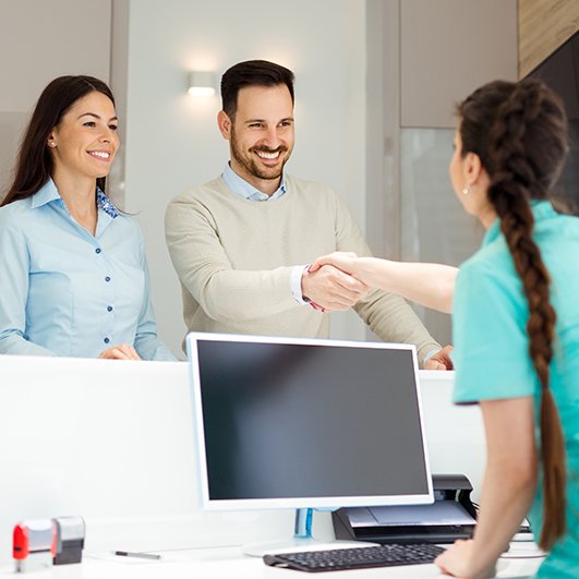 Man and woman checking in at dental office