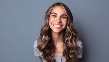 woman smiling about the cost of Invisalign in Eatontown