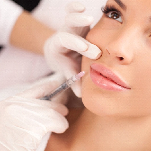 Cosmetic dentist administering Juvéderm in Eatontown