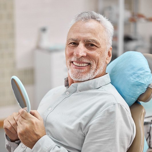 Older man smiling after smile makeover in Eatontown, NJ