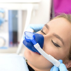 Woman relaxing with nitrous oxide dental sedation in Eatontown