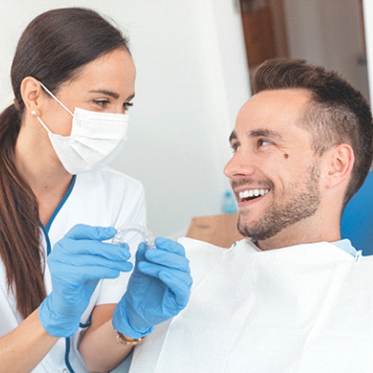 Happy man at appointment for Nu Smile Aligners