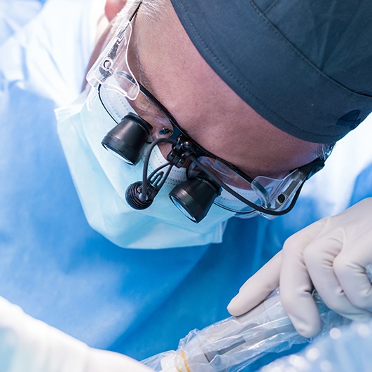 Dentist performing osseous surgery