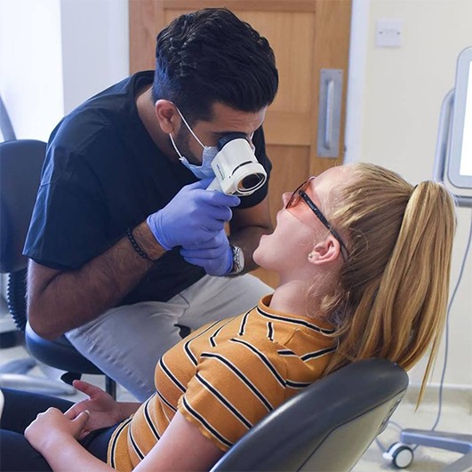 Patient receiving oral cancer screening