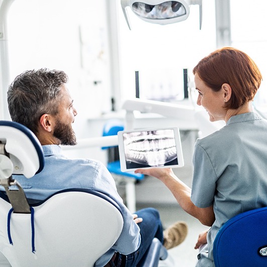 Is it right for me:patient talking to dentist during consultation 