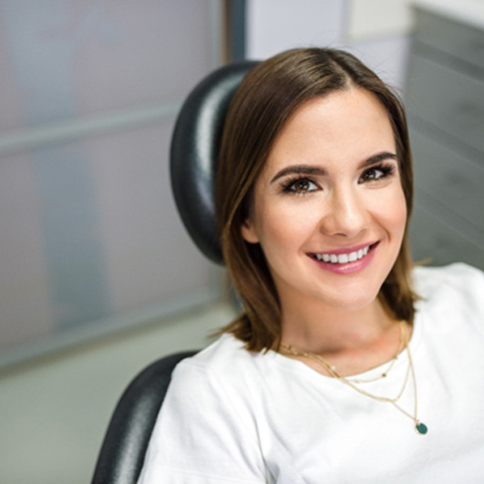 Close-up of woman in white shirt in dental chair