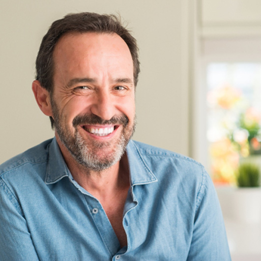 Bearded man smiling at home