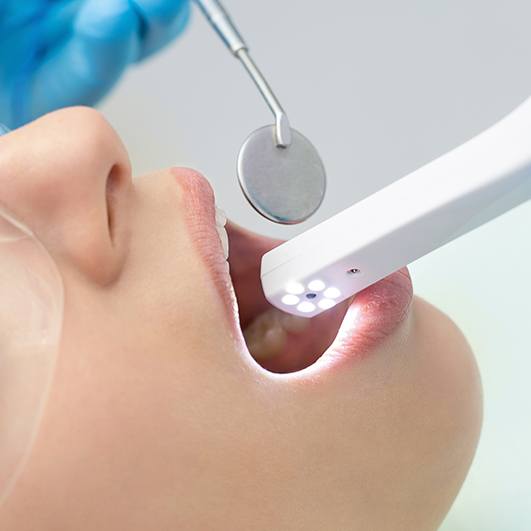 Dentist capturing smile images with intraoral camera