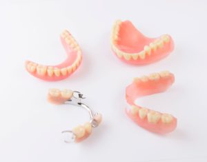 Full and partial dentures sitting on a white background