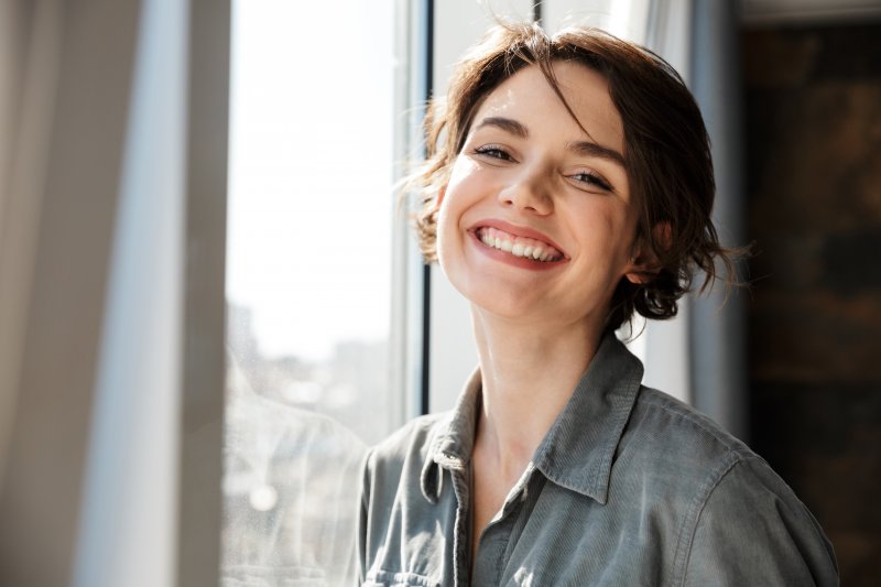 A woman smiling after her cosmetic dentistry treatments