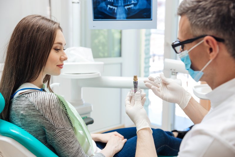 Dentist talking to patient about a dental implant