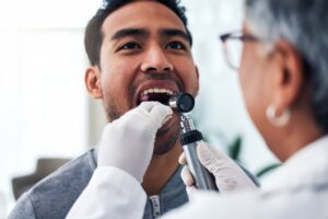 Man being checked for oral cancer